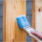 Paint brush on wooden fence